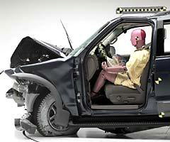 The dummy's position in relation to the steering wheel and instrument panel after the crash test indicates the driver's survival space was maintained reasonably well