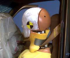 The safety belt caught the dummy's neck when its head went out the open door