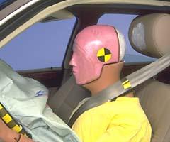 SSmeared greasepaint shows where the dummy's head hit the head restraint after rebounding from the airbag. The good dummy motion throughout the crash was marred only by excessive upward movement of the steering wheel