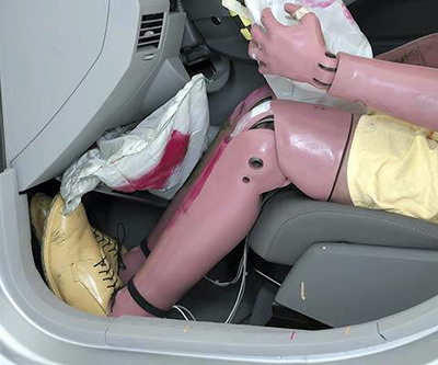 The Caliber features an airbag that deploys from the knee bolster underneath the steering wheel. The dummy's knees and shins hit this airbag as indicated by smeared greasepaint, and all leg and foot injury measures were low