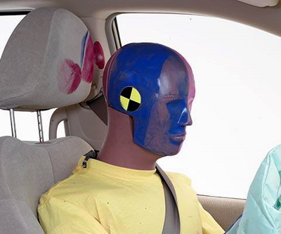 Smeared greasepaint indicates where the dummy's head hit the roof rail, grab handle, and head restraint during rebound. Head accelerations from these hits were low.