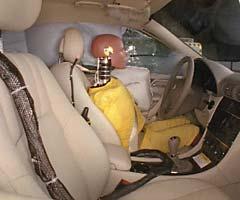 Action shot taken during the side impact crash test showing the driver dummy's head was protected from being hit by hard structures by the side airbags