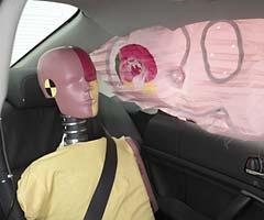 Action shot taken during the side impact crash test showing the driver dummy's head was protected from being hit by hard structures by the side curtain airbag