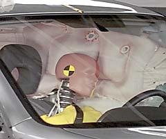 Action shot taken during the side impact crash test showing the driver dummy's head was protected from being hit by hard structures by the side curtain airbag