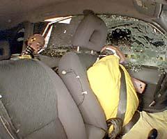 Action shot taken during the side impact crash test showing the driver dummy's head was protected from being hit by hard structures by the side curtain airbag
