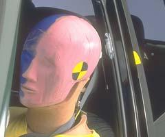 White paint on the B-pillar indicates where the dummy's head hit, producing moderately high head acceleration